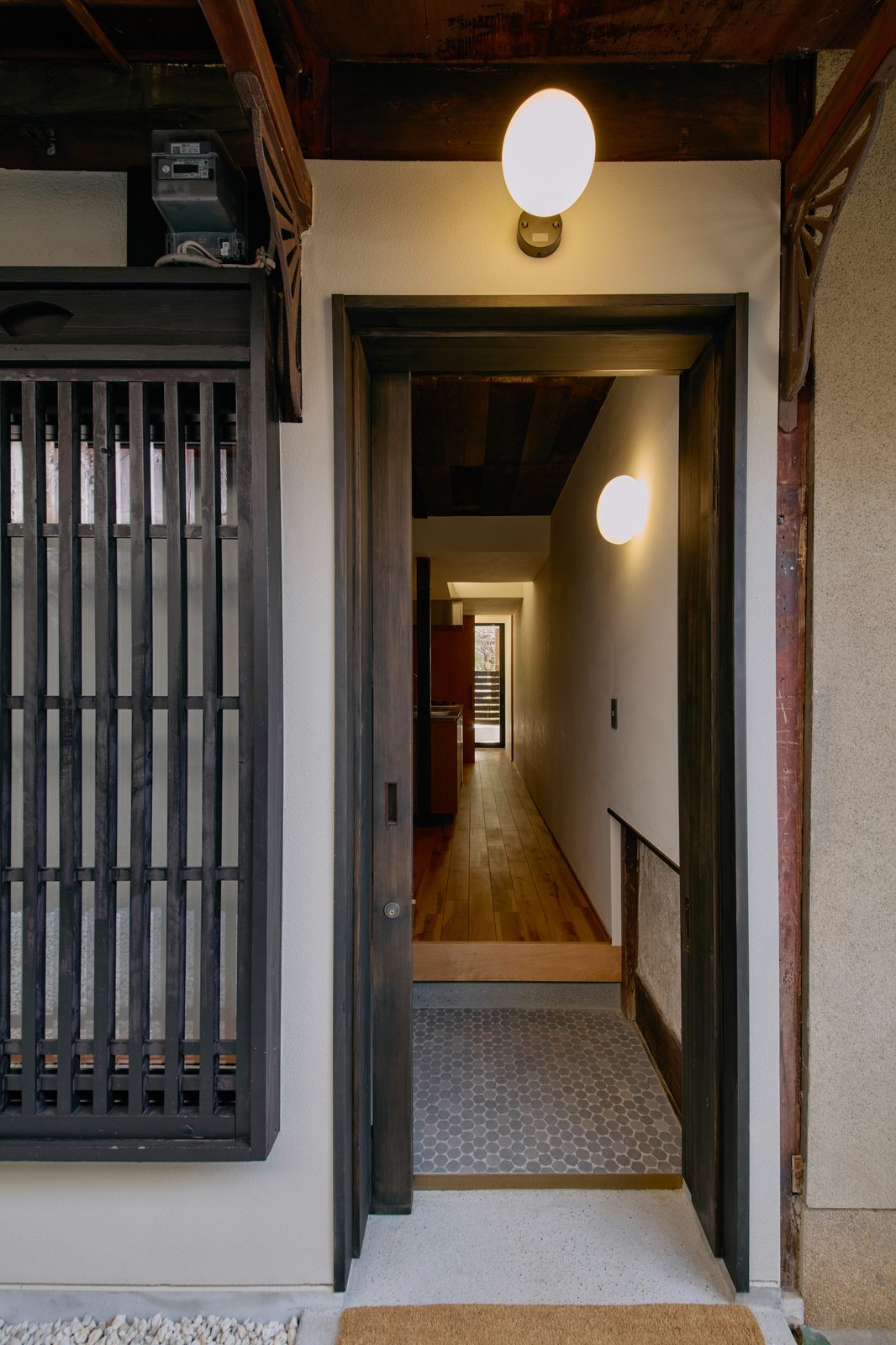 Entry hallway with hexagonal tile and globe lights