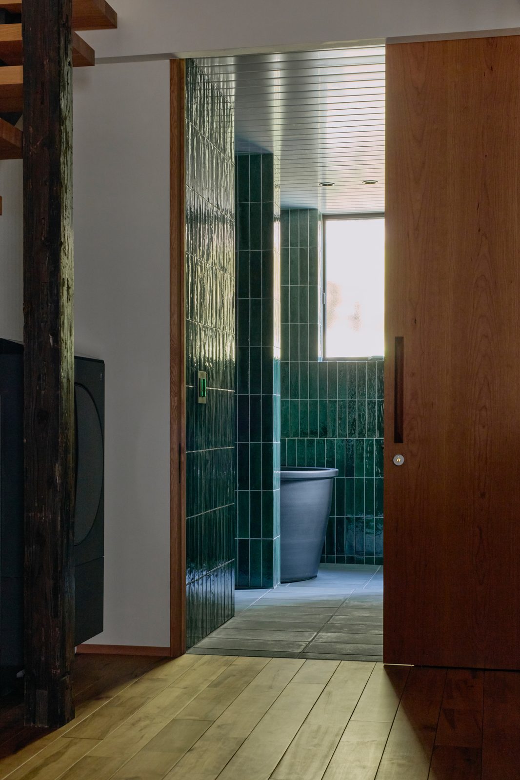 Bathroom with Oribe green tile and soaking tub