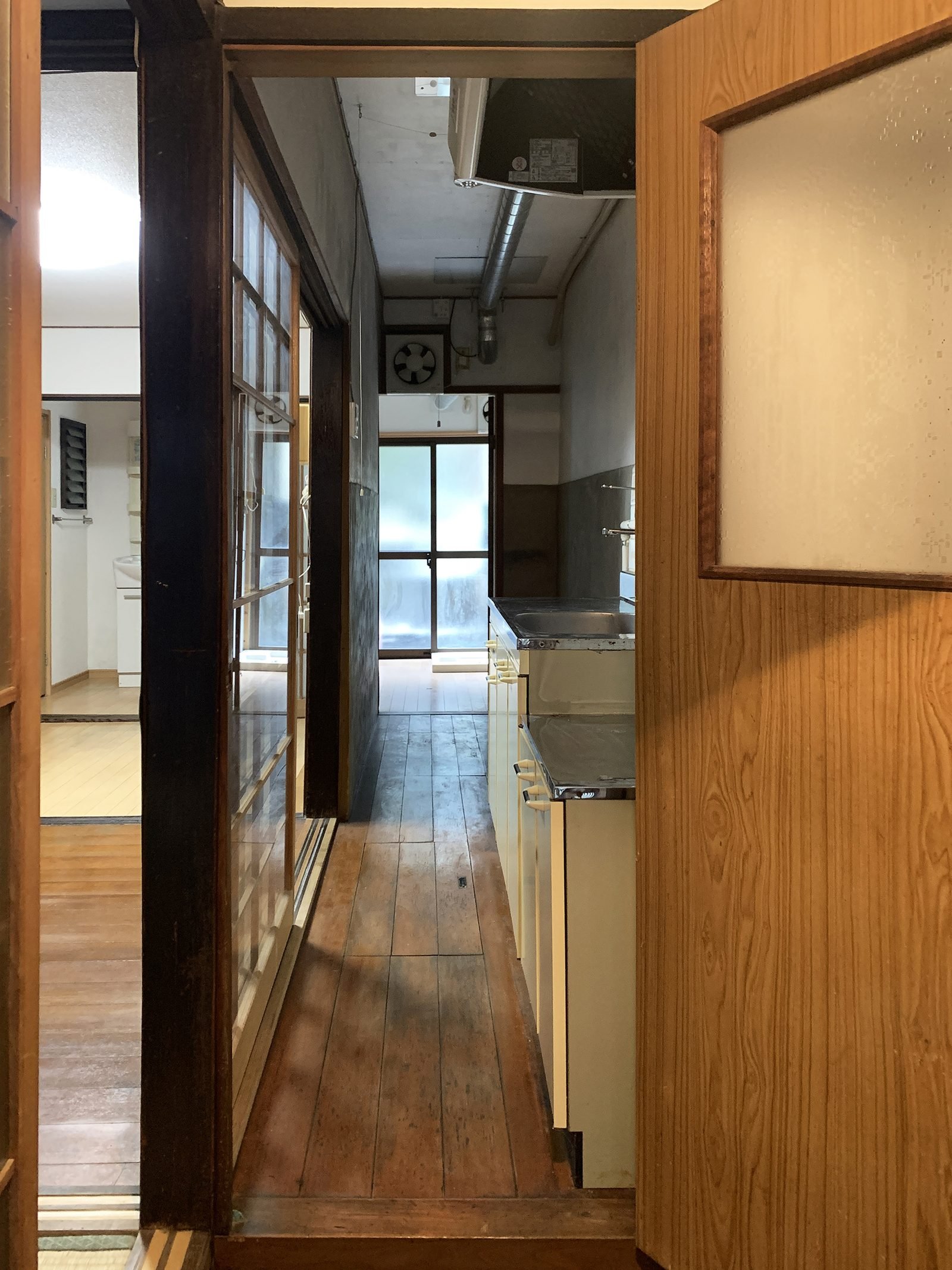 Original kitchen corridor with worn wood floors