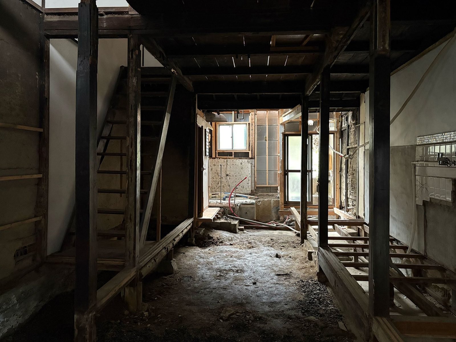 Full demolition revealing post-and-beam skeleton