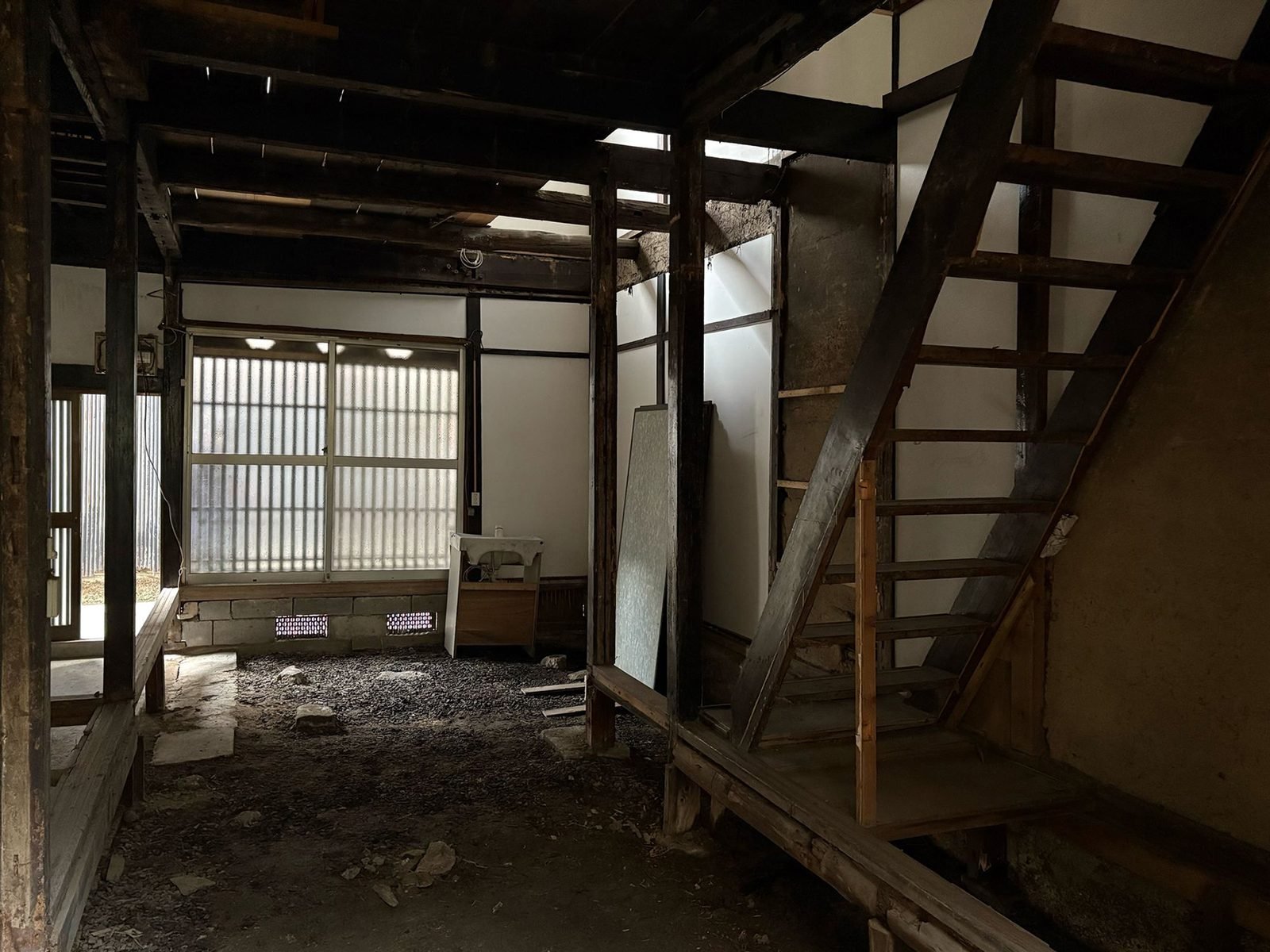 Exposed structure with original staircase and soot-darkened beams
