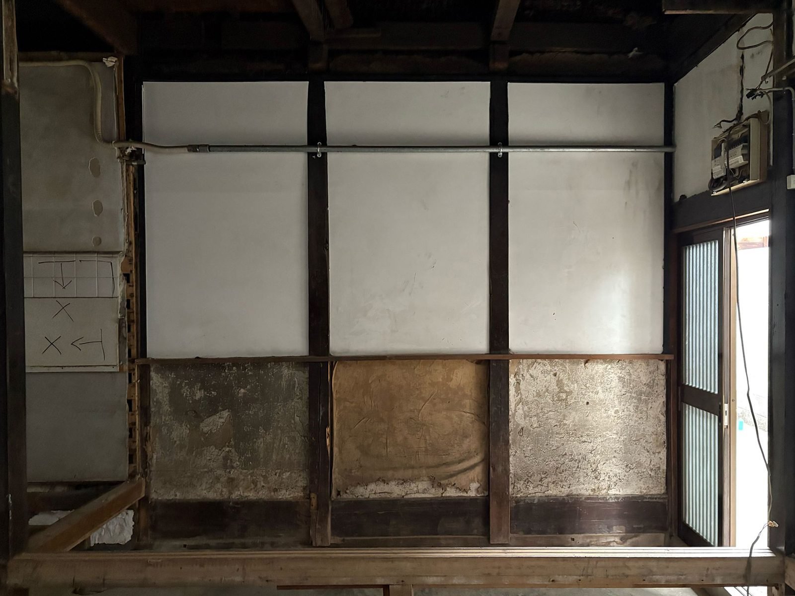 Wall layers revealed, plaster over original earthen walls