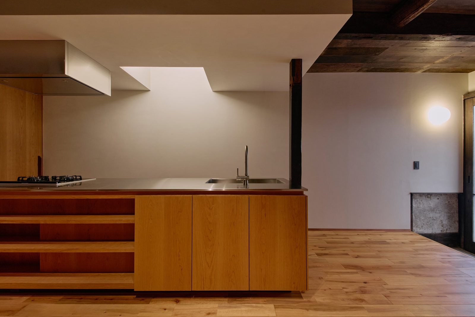New kitchen island with stainless steel counter and cypress cabinetry
