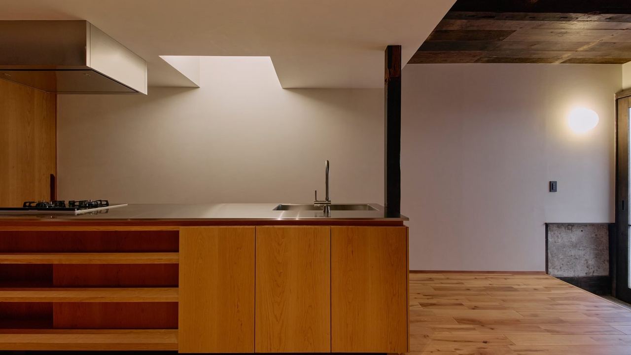 Kitchen with stainless steel counter and cypress cabinetry